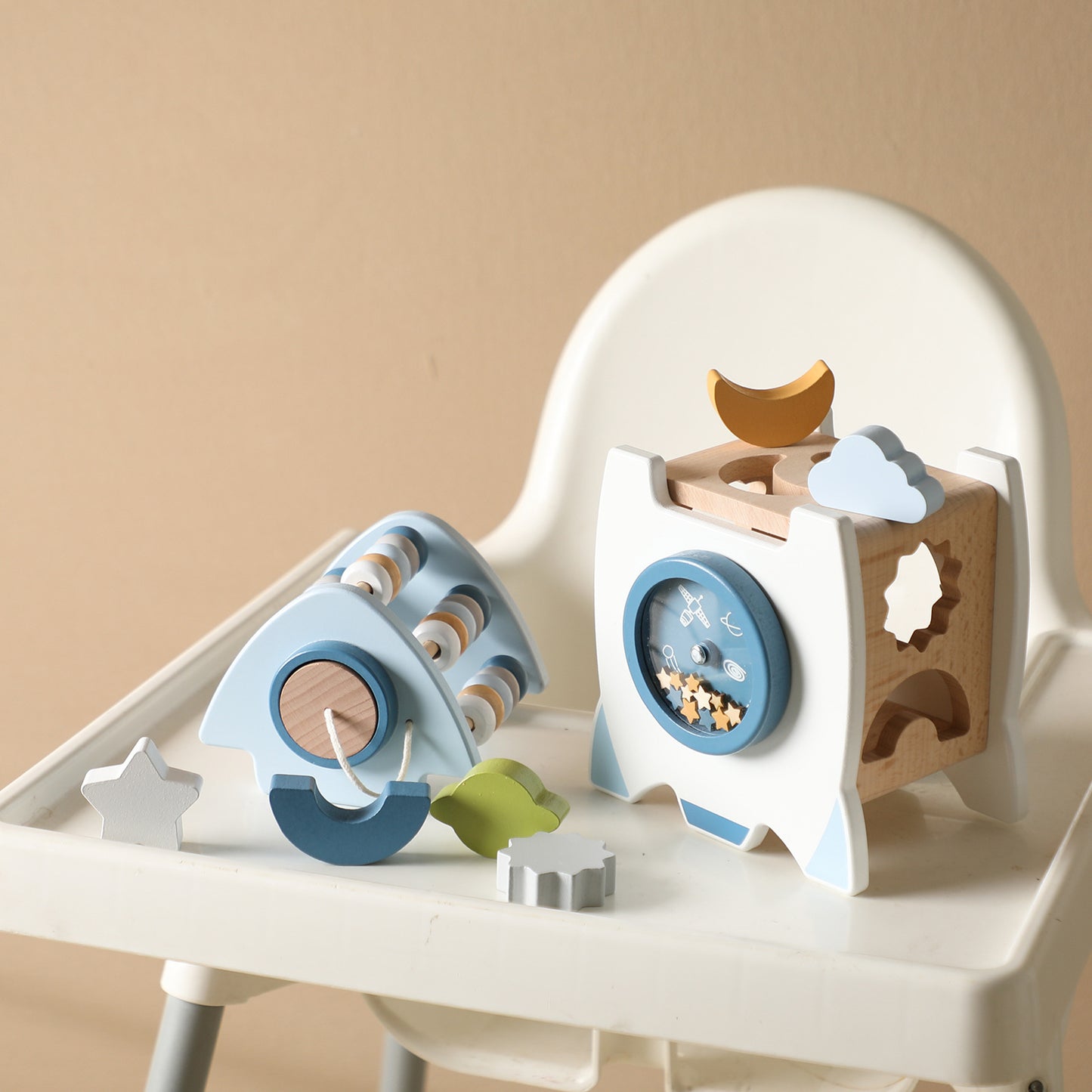Wooden toy set with various shapes and a clock on a white surface.