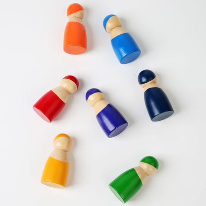 Set of colorful wooden peg dolls on a white background