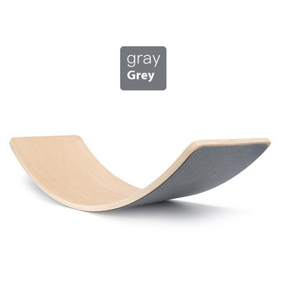 Wooden balance board with gray seat on a white background