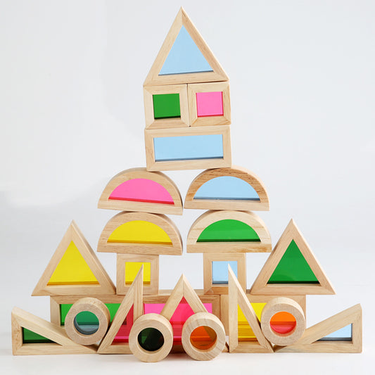 Colorful wooden geometric blocks stacked on a white background