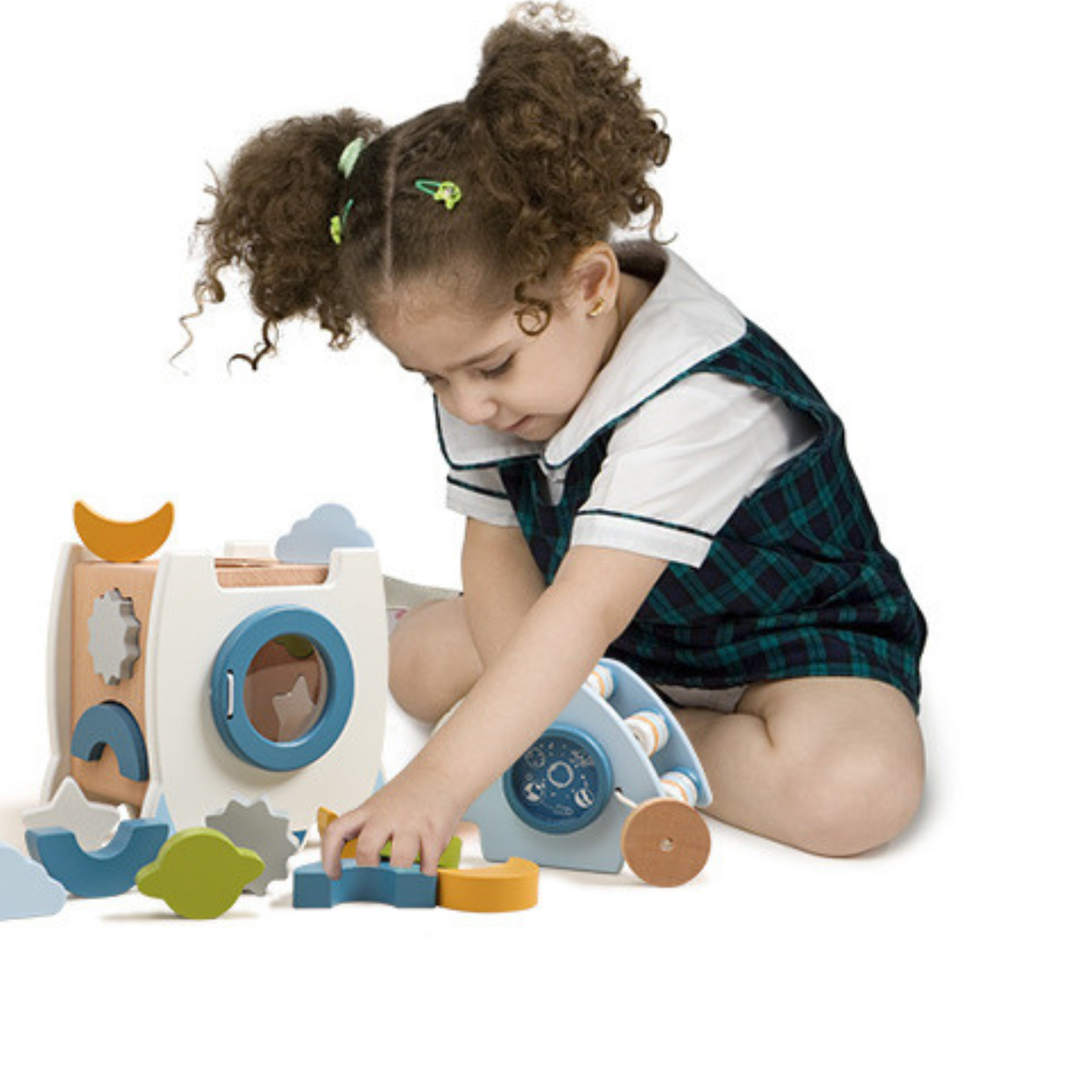Child playing with a wooden shape sorter toy on a white background