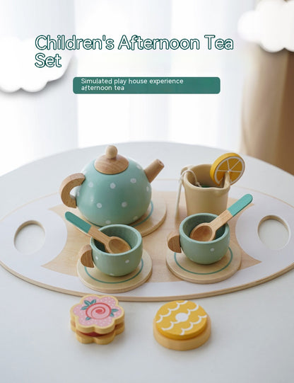 Children's afternoon tea set with teapot, cups, and cookies on a white surface.