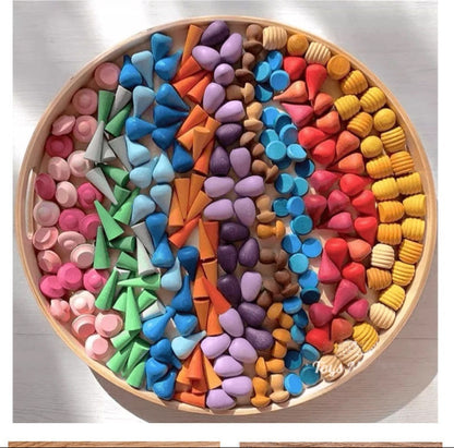 Colorful building blocks in a wooden box with text about educational enlightenment and creativity.