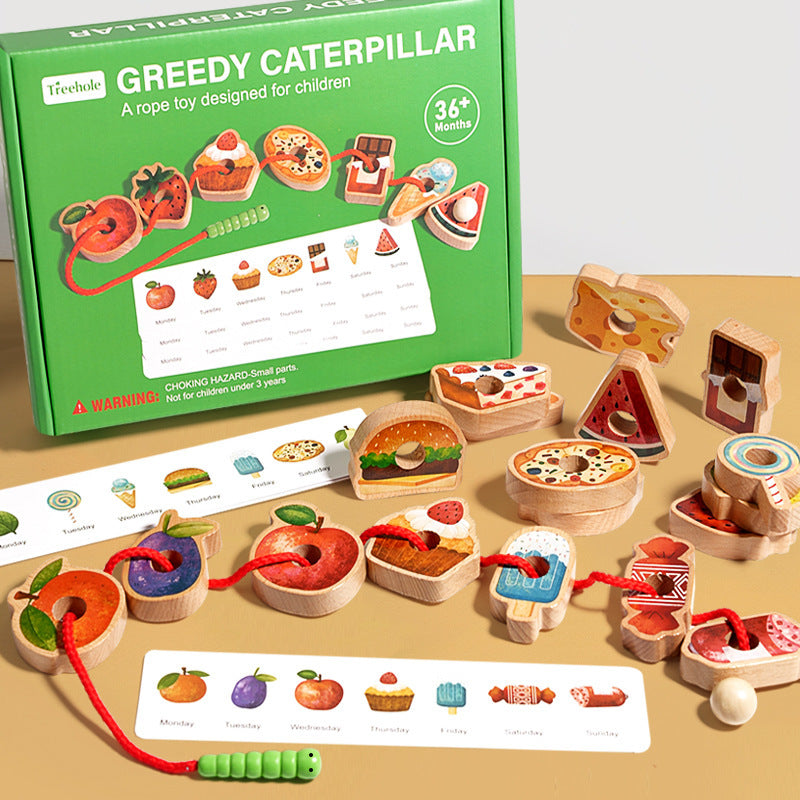Wooden toy set with 'Greedy Caterpillar' packaging on a beige surface