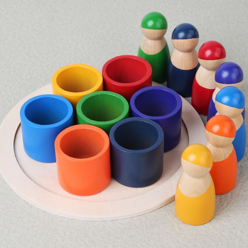 Colorful wooden pegs and cups on a light gray background