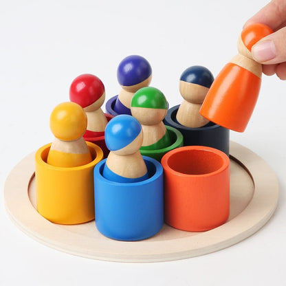 Colorful wooden pegs in cups on a white background