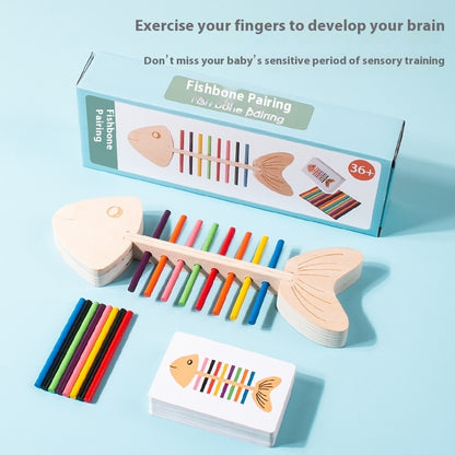 Wooden fish-shaped xylophone with colorful sticks and packaging on a light blue background