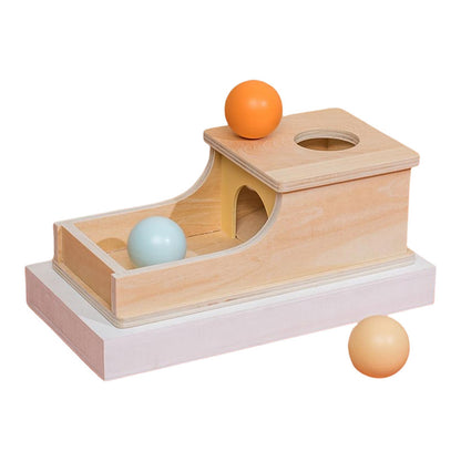 Wooden toy with three spheres of different colors on a white background