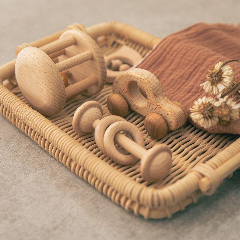 Wooden toys on a woven tray with a textured surface