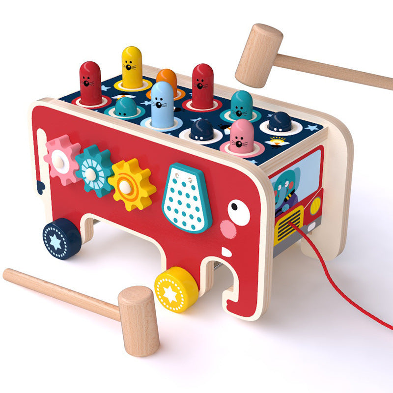 Colorful wooden toy with various shapes and a hammer on a white background