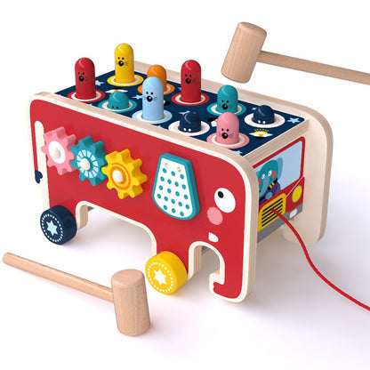 Colorful wooden toy with various shapes and a hammer on a white background