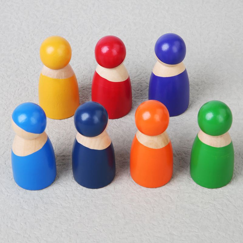 Set of colorful wooden peg people on a light gray background