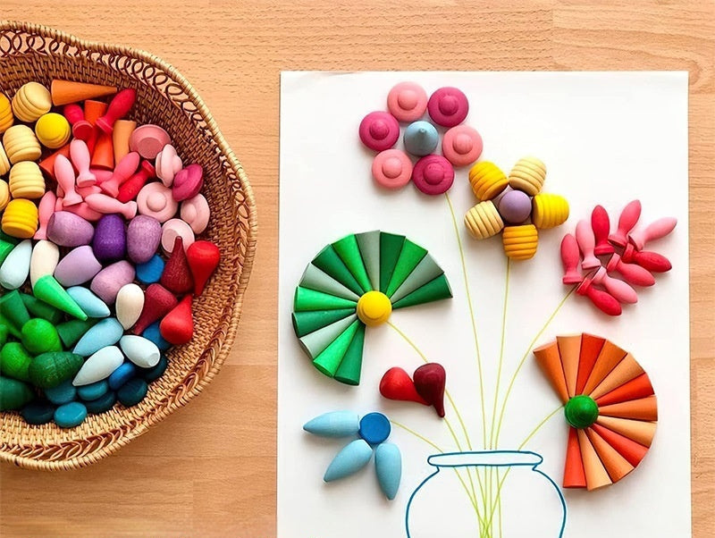 Colorful building blocks shaped like flowers on a paper design, with a basket of blocks on a wooden surface.